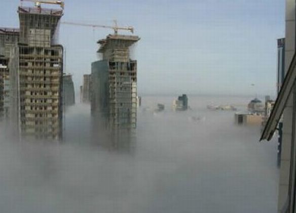 bird's-eye view of buildings above the clouds