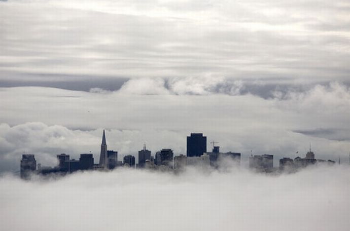 bird's-eye view of buildings above the clouds