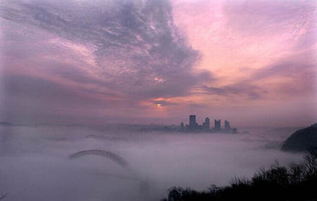 bird's-eye view of buildings above the clouds