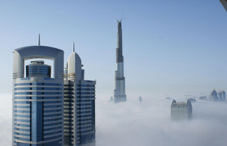 bird's-eye view of buildings above the clouds