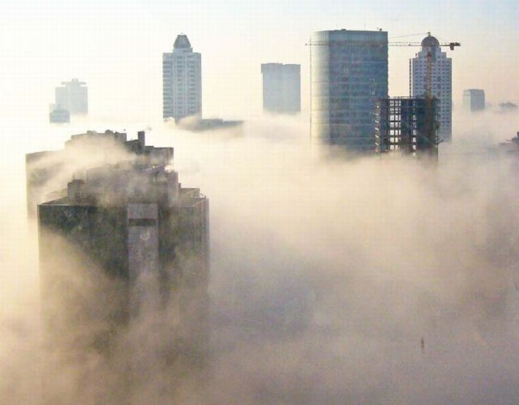 bird's-eye view of buildings above the clouds